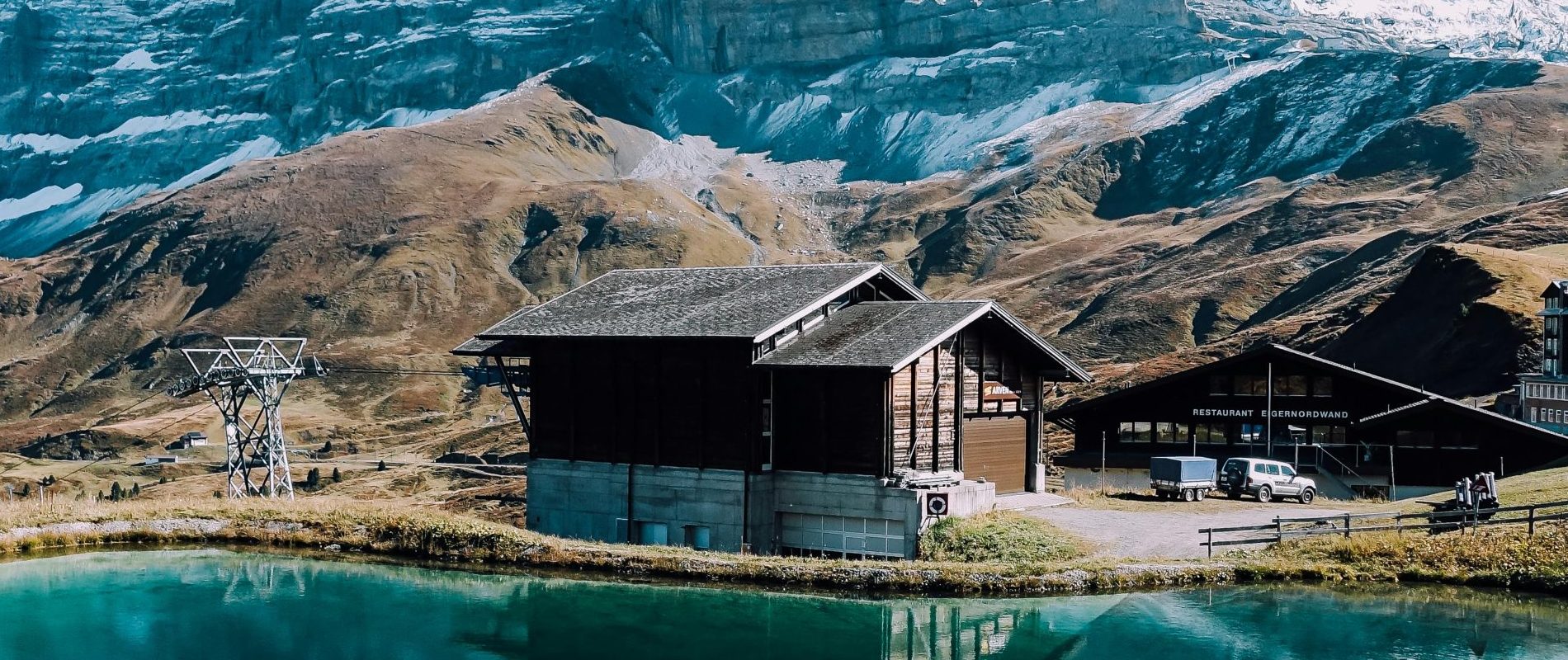 Move to Switzerland With VanOne - Sachseln, OW, Switzerland,  Brown wood house and mountain reflected in a crystal clear water Lake